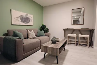 a living room with a couch and a table at Edgemont Retreat, Groups, River Cree, WEM, Disney in Edmonton
