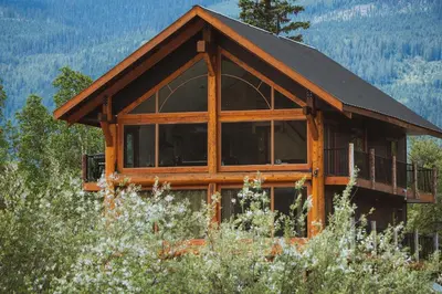 a large wooden cabin with a black roof at River Safari Eagles Nest in Blue River
