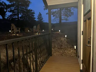 a porch of a house with chairs and candles at Sagebrush Caboose in Okanagan Falls