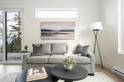 a living room with a couch and a table at Mountain Suite - Ocean View Fire Pit - Fully Equipped Kitchen - WD in Nanaimo
