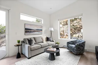 a living room with a couch and a chair at Mountain Suite - Ocean View Fire Pit - Fully Equipped Kitchen - WD in Nanaimo