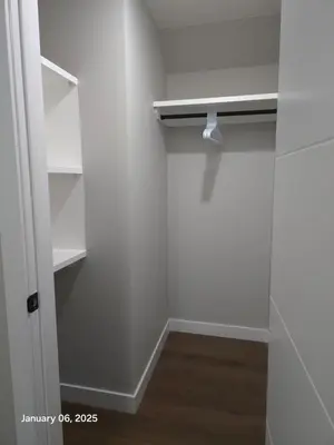 a room with white walls and a white closet at Lovely home in Northwest Calgary in Calgary