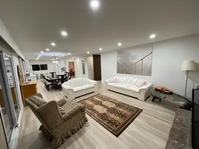 a living room with two couches and a dining room at Lionsbay in Lions Bay