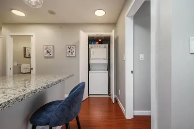 a kitchen with a counter and a refrigerator at Cozy Condo! Central Location! Plus One Free Parking! in Vancouver