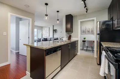 a kitchen with a sink and a counter top at Cozy Condo! Central Location! Plus One Free Parking! in Vancouver
