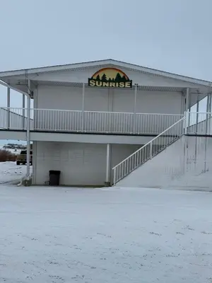 a building with a sign on the side of it at Sunrise Motel in Consort