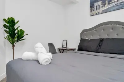a bedroom with a bed with towels on it at Private Chic Orchard Getaway in Edmonton