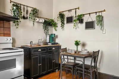 a kitchen with a table and some plants on the wall at The Accountant - Sleeps 3 Guests - DT Drumheller in Drumheller