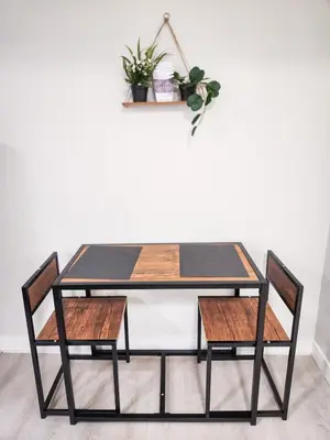 a dining room table with two chairs at Calgary Cozy Nest 2BR Suite in Calgary