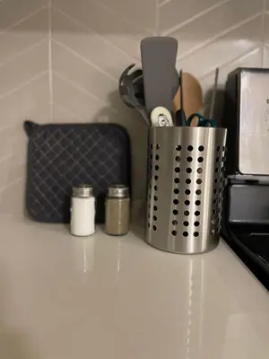 a container of utensils sitting on top of a counter at Calgary Cozy Nest 2BR Suite in Calgary