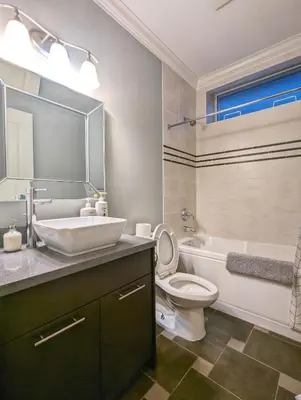 a bathroom with a sink and a toilet and a tub at Cozy home in Vancouver in Vancouver