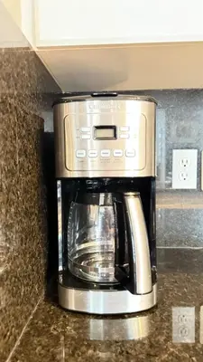 a coffeemaker sitting on a counter in a kitchen at The Ridge Escape-3BR Deluxe Stay in Calgary