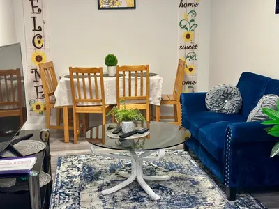 a living room with a blue couch and a table at Global Family Canada in Calgary