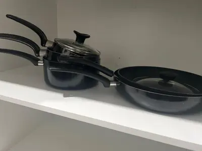 a pot and a pan sitting on a stove at Glacier Ridge 1 bedroom haven in Calgary