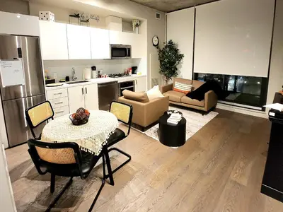 a kitchen and a living room with a table and chairs at Luxurious Downtown condo with spectacular views in Calgary