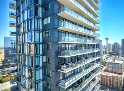 an image of a tall building with glass windows at Luxurious Downtown condo with spectacular views in Calgary
