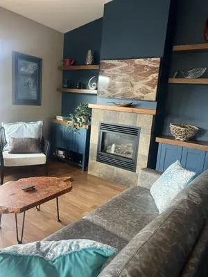 a living room with a couch and a fireplace at The Moorage - Luxury 2 bed & 2 bath Condo on Marina in Ucluelet