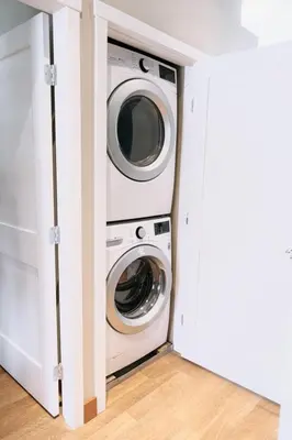 a washing machine and a washer and dryer in a room at The Moorage - Luxury 2 bed & 2 bath Condo on Marina in Ucluelet