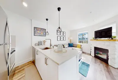 a kitchen and living room with a fireplace at Beautiful 1BR in Village Centre in Whistler