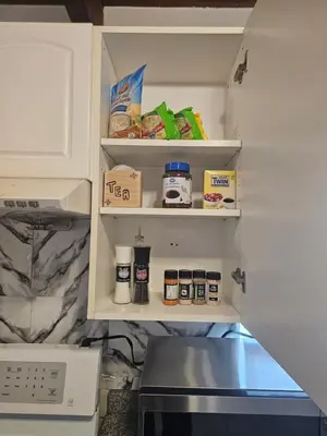 a refrigerator with its door open with food in it at P&N Suites - DELUXE QUEEN ROOM- LONDON in Edmonton
