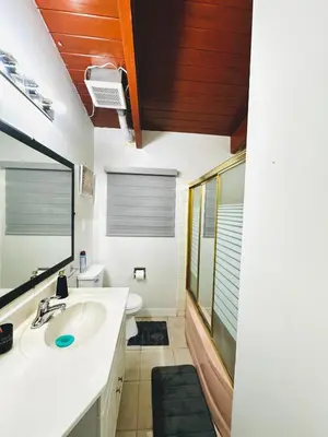 a bathroom with a sink and a toilet at P&N Suites - DELUXE QUEEN ROOM- LONDON in Edmonton