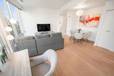 a living room with a gray couch and a table at Modern & Cozy Home in the Heart of Downtown Vancouver in Vancouver
