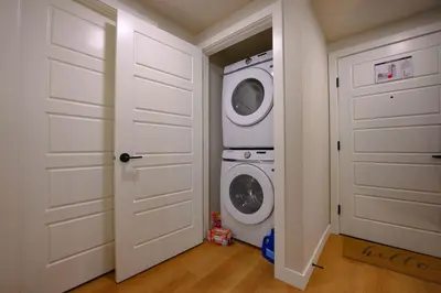 a laundry room with a washer and dryer at 2 bedrooms-3 beds 2 baths-Rocky Creekside Retreat - Top Floor - Heated Pool and Hot Tub in Dead Man's Flats