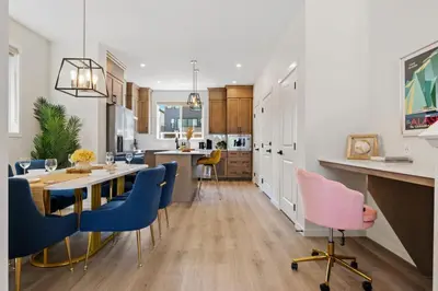 a kitchen and dining room with a dining table and chairs at 3 Bedroom Detached Home with Free Parking, Netflix, Free Banff Pass, King Size Bed & Portable AC in Balzac