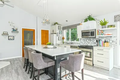 a kitchen with a table and chairs in it at Bayview Bed and Breakfast in Mill Bay