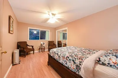 a bedroom with a bed and a ceiling fan at Fort Wine Burrow, Entire Private Estate Home in Maple Ridge District Municipality