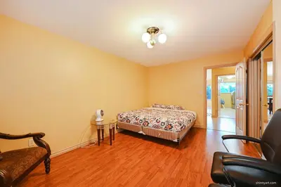 a bedroom with a bed and a table and a chair at Fort Wine Burrow, Entire Private Estate Home in Maple Ridge District Municipality