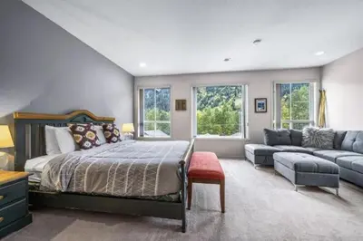 a large bedroom with a bed and a couch at The Marmot's Den in Sun Peaks