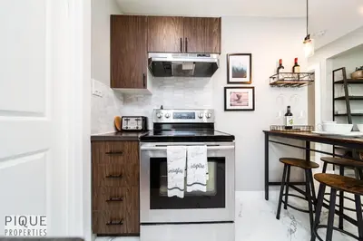 a kitchen with a stove and a counter at Park Life Escape-King Beds-Sleeps 10-Pet Friendly in Edmonton
