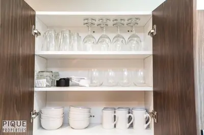 a cupboard filled with glasses and other items at Park Life Escape-King Beds-Sleeps 10-Pet Friendly in Edmonton