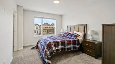 a bedroom with a bed and a window at A Home away from Home in Calgary