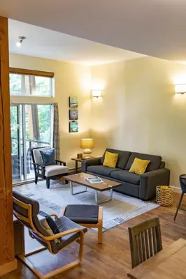 a living room with a couch and chairs at Surfers' Nest - Waterfront home in Ucluelet in Ucluelet