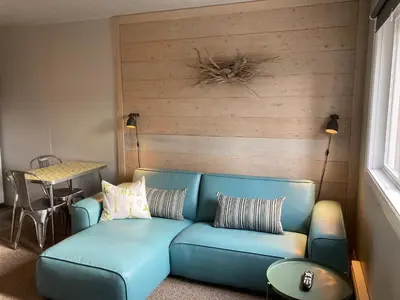 a blue couch in a living room with a table at Pinewood Inn in Golden