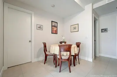 a dining room with a table and chairs at O Charming Bright Queen Bed Room Ensuite in West Vancouver