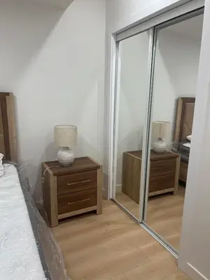 a bedroom with a mirror on a dresser and a bed at Midas Haven in Edmonton