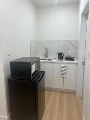 a kitchen with a microwave on top of a refrigerator at Midas Haven in Edmonton