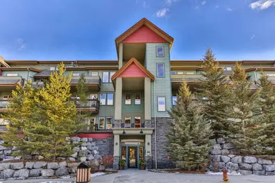 a large building with a red roof at Summit at The Lodges of Canmore in Canmore