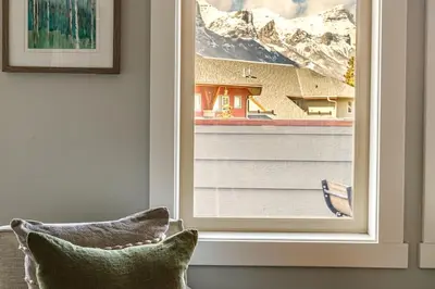 a window with a view of a snowy mountain at Mountain Memories Family Fun at The Lodges in Canmore