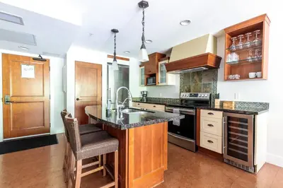 a kitchen with a sink and a counter top at Pooches Paradise - Pet Friendly Hot Tub & Pool in Canmore