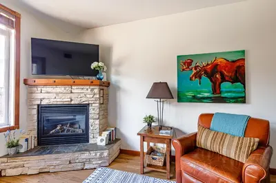 a living room with a couch and a fireplace at Mountain Paradise at Falcon Crest Lodge in Canmore