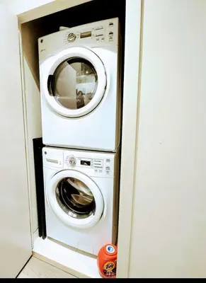 a washer and a washing machine in a room at Breath Taking View for 4Guest DTskyline-22nd Floor in Calgary