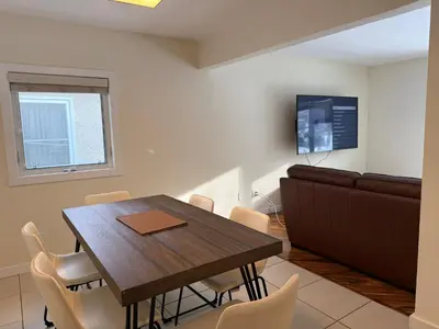 a dining room with a wooden table and chairs at 2Bed Bright & Stylish Ritchie Urban Retreat in Edmonton
