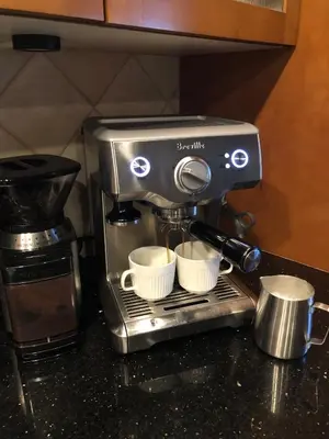 a coffee maker sitting on a counter with two cups at Best Location Available in Whistler Village in Whistler