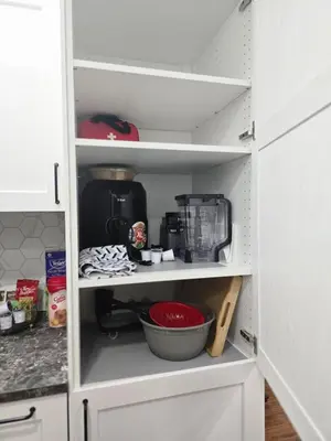 a kitchen pantry with a cupboard filled with food at Cozy & Spacious 1-Bedroom SW Calgary near SpruceMeadows in Calgary