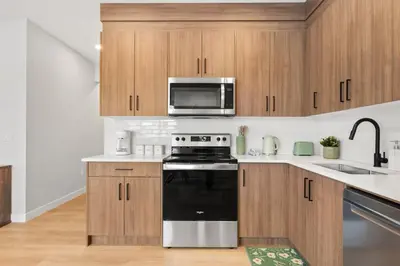 a kitchen with a stove and a microwave at 2 Bedroom Spacious & Private Guest Suite - King Size Bed TV in Room, 58