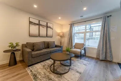 a living room with a couch and a table at Skyridge by Canmore Premier in Canmore